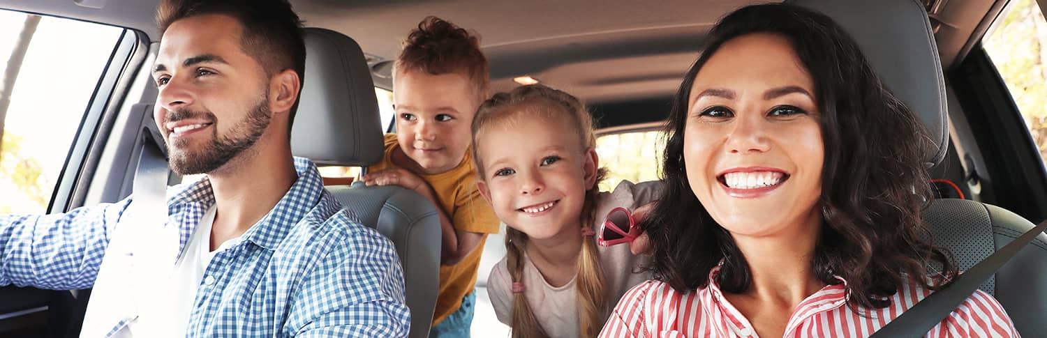 Photo of family sitting inside of a car